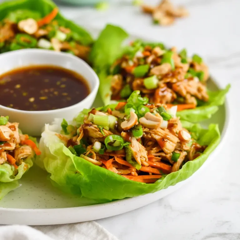 Warm chicken filling spooned into crisp lettuce leaves for a fresh and light lunch.