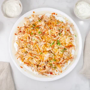 adding chicken and cheese to tortilla for wrap recipe